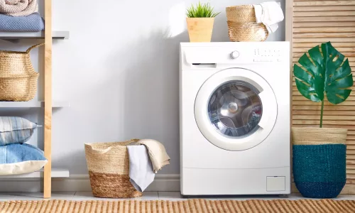 Interior of a real laundry room with a washing machine at home